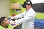 El doctor Edwin Villacís revisa el estado de los ojos a un menor de edad.
