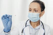 close-up-doctor-holding-cotton-swab