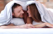 lovely-couple-in-bed-under-the-covers