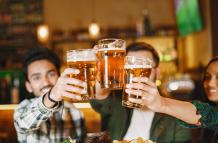 indian-friends-in-pub-guys-and-girl-at-bar-celebration-over-mug-of-beer