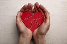 top-view-hands-holding-stapled-broken-heart