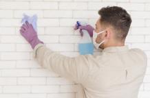 medium-shot-man-disinfecting-wall