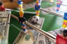 table-football-game-with-us-dollar-bills-scattered-2023-11-27-05-09-44-utc