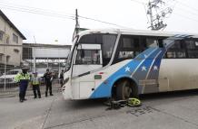 La moto quedó debajo del transporte urbano, mientras que los cascos de los ocupantes quedaron tirados en la avenida.