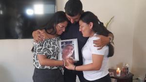 Los tres hijos de la víctima sostienen un portarretrato con la imagen de su padre. Está sonriente. Así lo recuerdan.