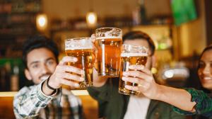 indian-friends-in-pub-guys-and-girl-at-bar-celebration-over-mug-of-beer