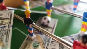 table-football-game-with-us-dollar-bills-scattered-2023-11-27-05-09-44-utc