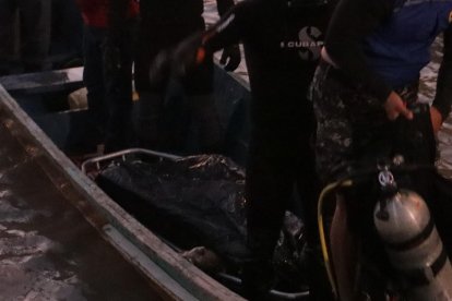 Instante en el que el cuerpo era trasladado a la orilla del Guayas.