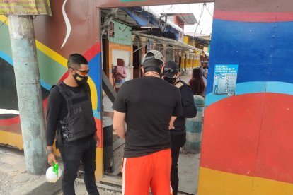 Antes de ingresar al lugar, a los usuarios se les mide la temperatura y se les rocía alcohol.