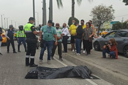 El cadáver fue cubierto con un plástico negro. Un familiar llegó para identificarlo.