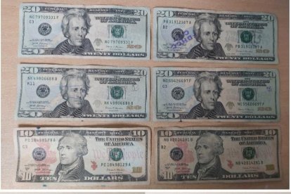 El celular y el dinero incautados al sospechoso.