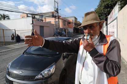 Un silbato de plástico que le regalaron los vecinos lo acompaña en su oficio. Permanece en la calle desde las 06:00 hasta las 20:00.