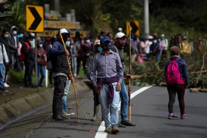 Indígenas de las comunidades de Cusubamba bloquean una carretera al norte de la ciudad durante una jornada de protestas contra el Gobierno, hoy, en Quito