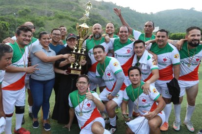 La selección máster del colegio San Agustín estuvo acompañada por el sacerdote Wilson Malavé (sosteniendo el trofeo).