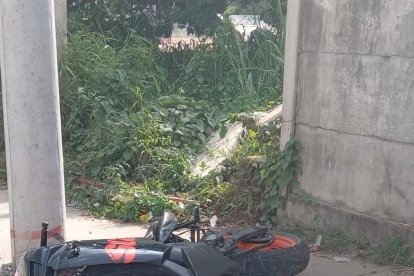 La motocicleta en la que se movilizaba el agente Paladines quedó contra un poste de alumbrado público.