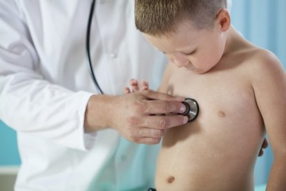 Doctor makes chest auscultation to little patient