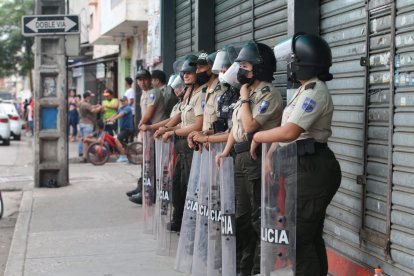 Policías patrullan a lo largo de la calle Q y también por la calle 29, en el suburbio de la urbe.