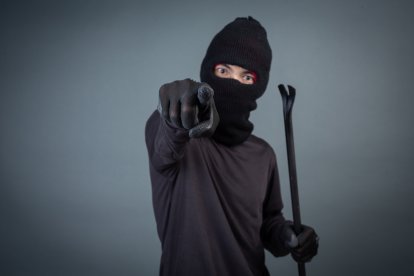 Black criminals wore a head yarn on a gray background.