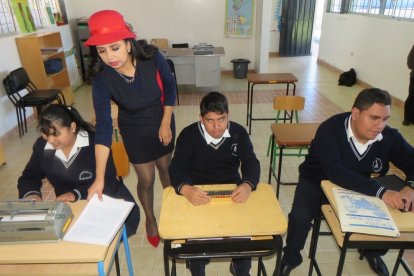 Jennifer, Darío y Ángel muestran los implementos que les han facilitado el aprendizaje.