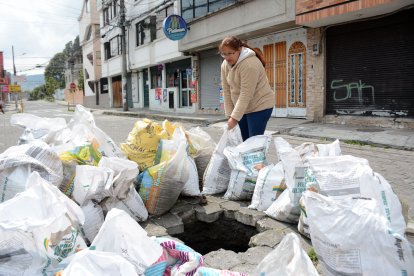 Moradores intentan precautelar la seguridad de peatones y conductores colocando objetos de advertencia.