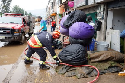 Los bomberos ayudaron a limpiar el desastre que dejó el aluvión en algunos locales del sector.