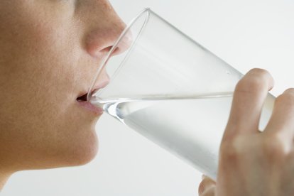 Woman Drinking Glass of Water --- Image by © Royalty-Free/Corbis.
