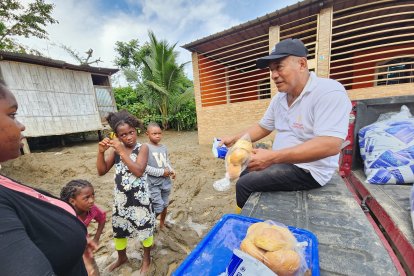 Mauro Sánchez va en una camioneta de barrio en barrio, para entregar las funditas con pan y, además, leche.