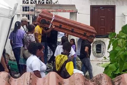 Amigos y familiares cargan el ataúd del joven.