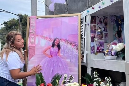 Anita López, la madre, junto al cuadro con el vestido que hubiese vestido su hija.