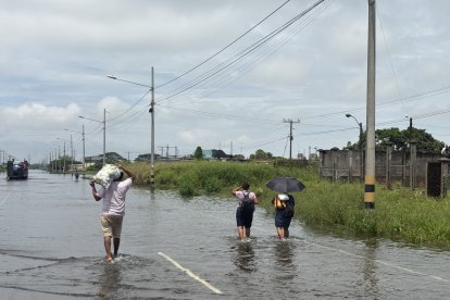 Los habitantes de los recinto de Pimocha también caminaron en medio de la inundación para llegar a sus hogares.