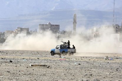 Vehículo con combatientes atraviesa un sector afectado por los combates recientes.