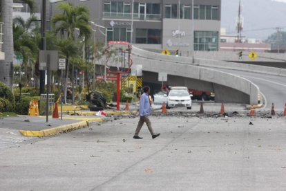 Restos del vehículo calcinado y escombros aún permanecen en la avenida Joaquín Orrantia, bajo custodia policial, casi 48 horas después del atentado con coche bomba.
