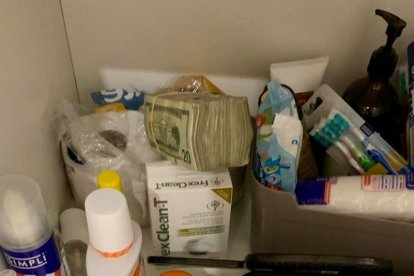 Criminalística de la Policía encontró 10.000 dólares en un mueble del lavabo de la casa de Christian Luvin Quito Carpio y a su pareja, Kléber Bryan Balarezo Mercado, el 16 de enero de 2025.