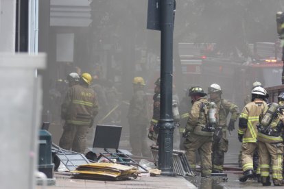 Bomberos trabajan en la extinción de un incendio que afectó tres locales en el centro de Guayaquil