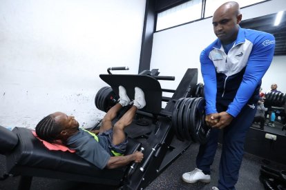 El arquero de la Tricolor de talla baja, Ángel Corozo, preparándose en el levantamiento de potencia.  El entrenador David de Jesús lo guía.