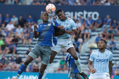 El delantero Jaime Ayoví (i), de Emelec, va a la disputa del balón contra el defensa Carlos Medina, de la Católica.