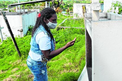 Yetty frente a la tumba de su madre, en Chontaduro. Limpia la lápida y le promete cumplir con lo que ella le pidió en el sueño.