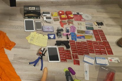 Entre las evidencias encontradas había tablets, una pistola, celulares, entre otros.