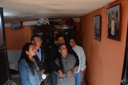 Los seres  queridos de Panchito miran con devoción el cuadro en donde está vestido con su sotana.
