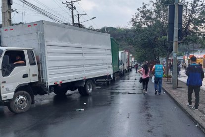 Militares custodian la entrega de los documentos mientras los coordinadores de mesas despachan los paquetes.