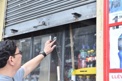 Un vecino señala la ventana por donde salió el disparo que hizo el presunto ladrón.