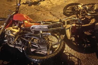 Una de las motocicletas tirada en la vía tras el choque.