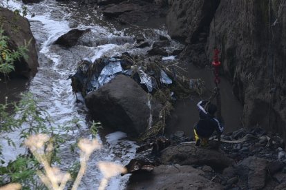 Un ciudadano bajó a una quebrada para intentar sacar el vehículo con una grúa pero no lo logró.