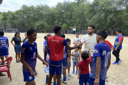 Charles Vélez saludando a los chicos de la escuela de fútbol.