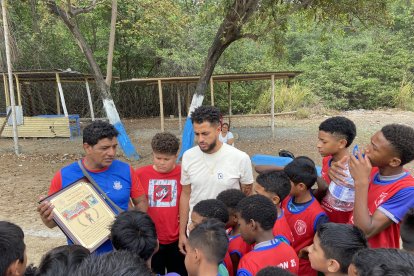 Charles Vélez recibiendo de José Moreira de la escuela Unión 25, una placa recordatoria.