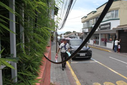 Las personas deben esquivar los ‘tallarines’ que cuelgan en las aceras.