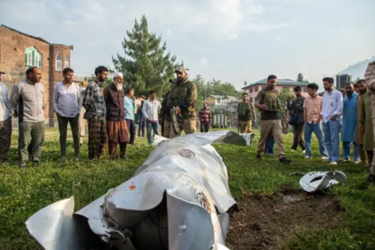 Personas observan los restos de un misil en Pakistán.