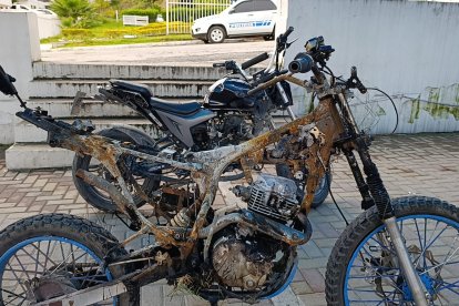 La motocicleta que estaban quemando dos sospechosos arrestados infraganti.