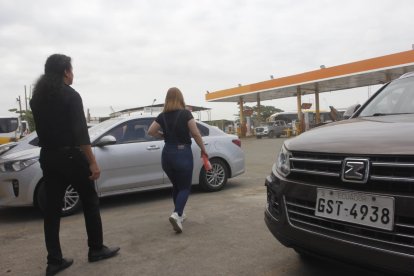 Clientes y trabajadores observan la gasolinera afectada luego de la balacera del martes 24 de marzo
