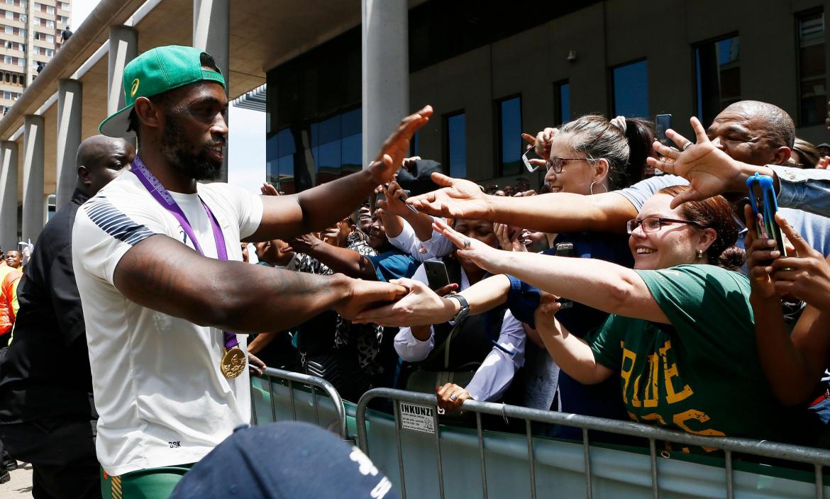 Springboks captain Siya Kolisi greets supporters during a parade thro